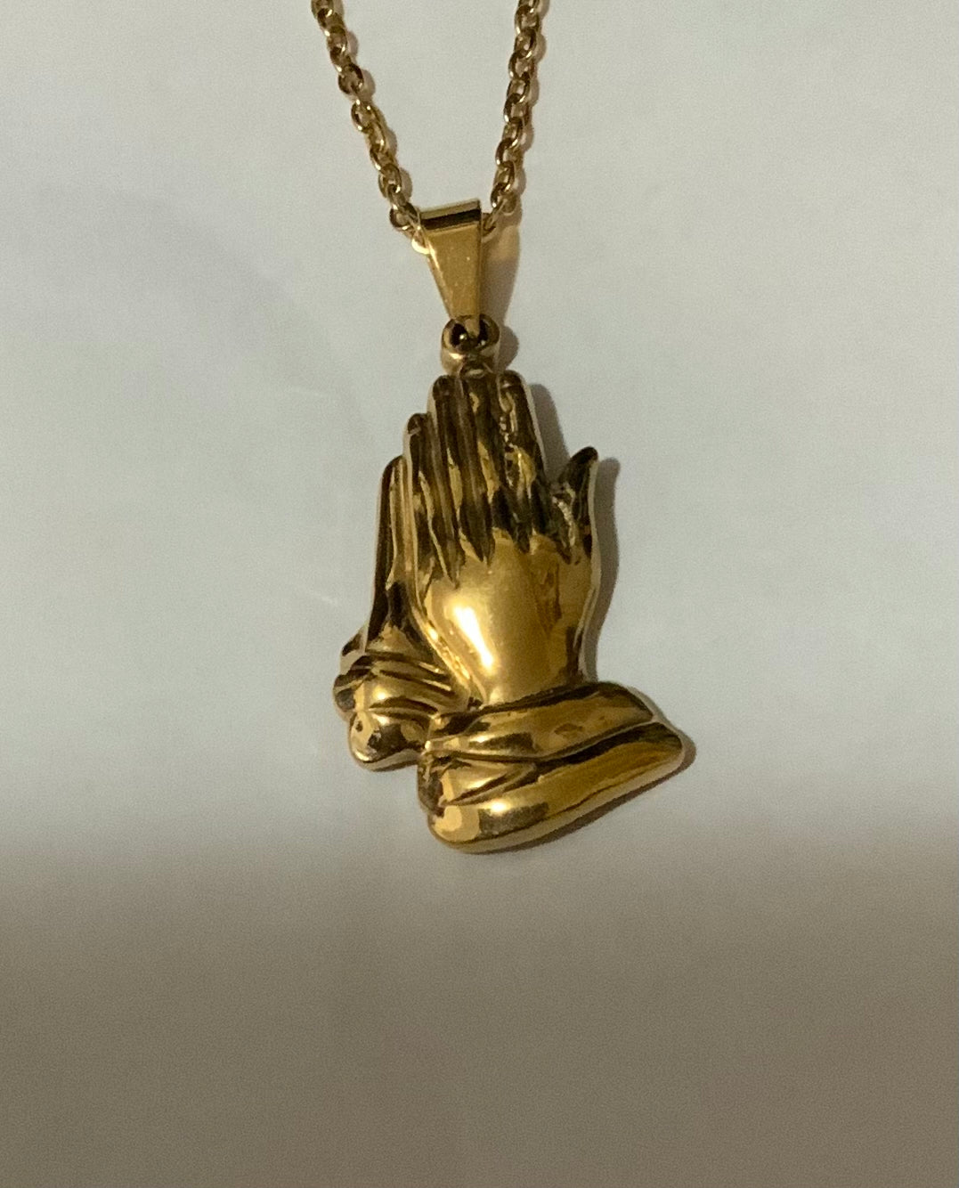 Gold tone praying hands pendant necklace. Stainless steel